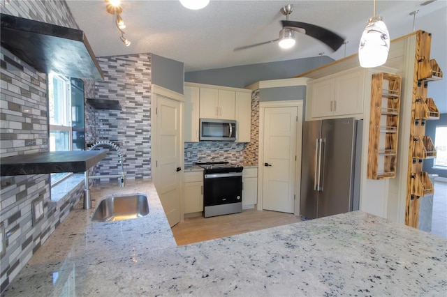 6172 Raleigh St, Spring Hill, FL 34606 - kitchen featuring stainless steel appliances, a sink, tasteful backsplash, light stone countertops, and ceiling fan