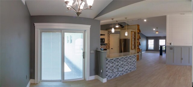 6172 Raleigh St, Spring Hill, FL 34606 - kitchen featuring appliances with stainless steel finishes, lofted ceiling, a chandelier, light wood-style flooring, and hanging light fixtures