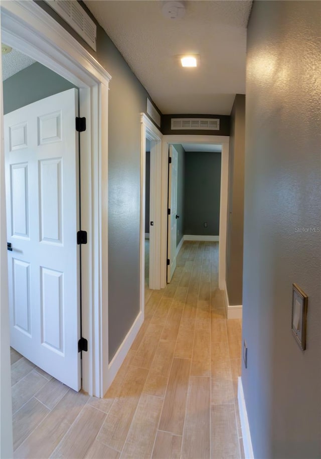 6172 Raleigh St, Spring Hill, FL 34606 - hallway featuring light wood-type flooring and baseboards