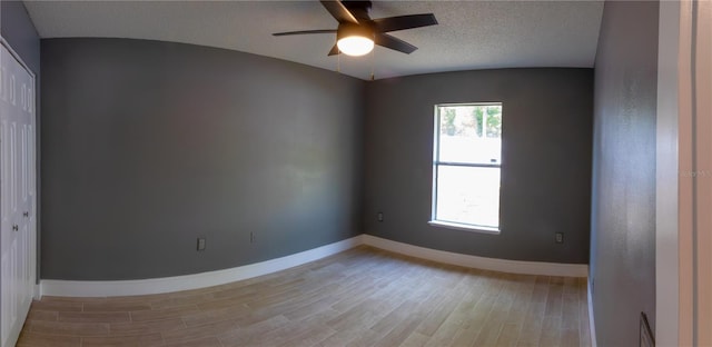 6172 Raleigh St, Spring Hill, FL 34606 - spare room with light wood-style flooring, ceiling fan, baseboards, and a textured ceiling