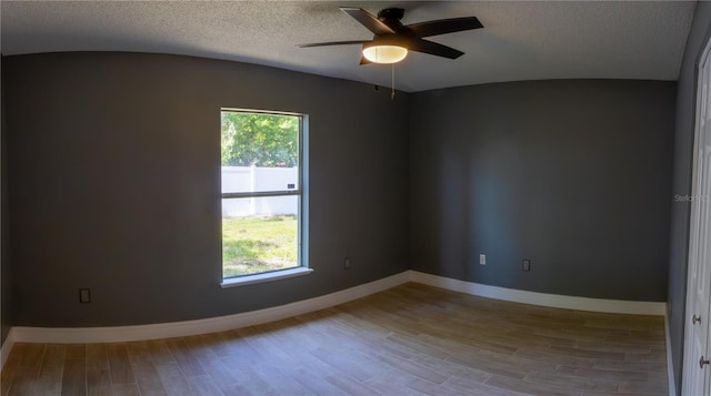 6172 Raleigh St, Spring Hill, FL 34606 - spare room with wood finished floors, a ceiling fan, baseboards, and a textured ceiling