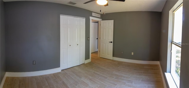 6172 Raleigh St, Spring Hill, FL 34606 - unfurnished bedroom with multiple windows, baseboards, a closet, and light wood-style flooring