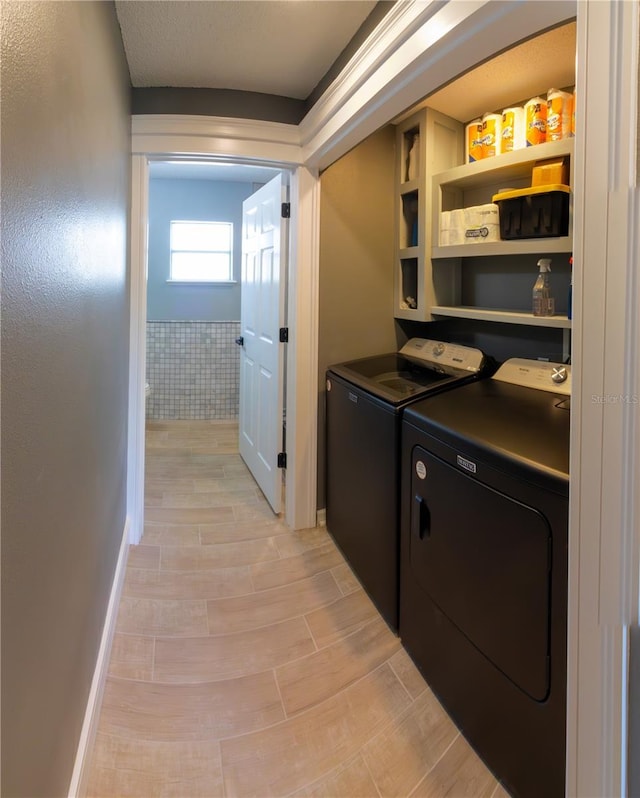 6172 Raleigh St, Spring Hill, FL 34606 - laundry area featuring independent washer and dryer, baseboards, and light wood-style flooring