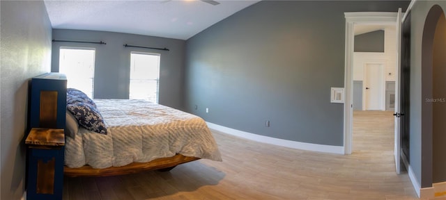 6172 Raleigh St, Spring Hill, FL 34606 - bedroom with lofted ceiling, light wood-type flooring, arched walkways, and baseboards