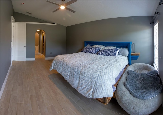 6172 Raleigh St, Spring Hill, FL 34606 - bedroom with arched walkways, lofted ceiling, wood finished floors, baseboards, and a ceiling fan