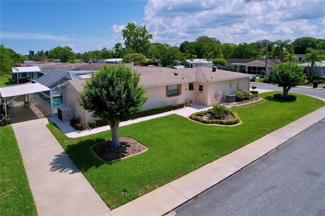 10111 Glen Moor Ln, Port Richey, FL 34668 - ranch-style home with cooling unit, a front yard, driveway, stucco siding, and a residential view