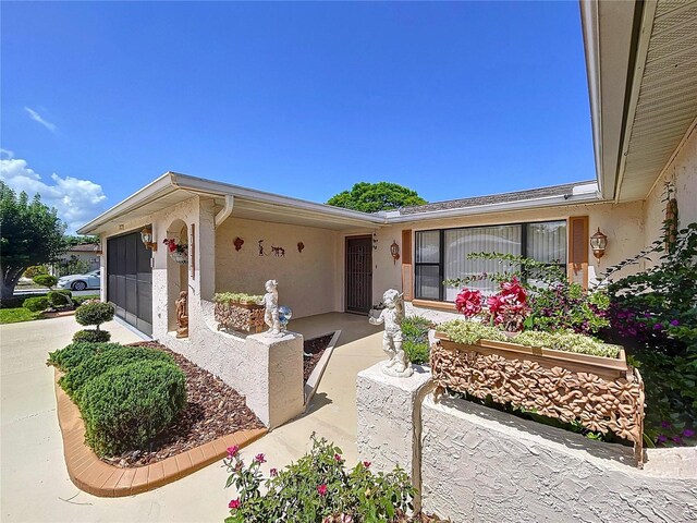 10111 Glen Moor Ln, Port Richey, FL 34668 - view of front of house with stucco siding and an attached garage