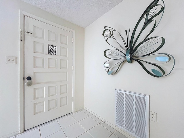 10111 Glen Moor Ln, Port Richey, FL 34668 - foyer featuring a textured ceiling and light tile patterned floors