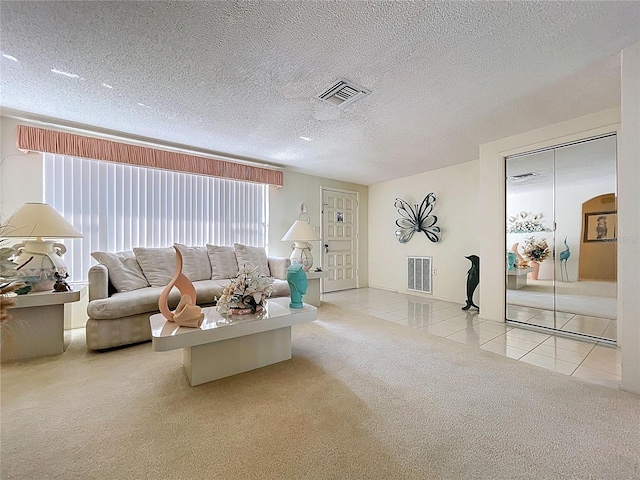 10111 Glen Moor Ln, Port Richey, FL 34668 - tiled living room featuring carpet floors and a textured ceiling