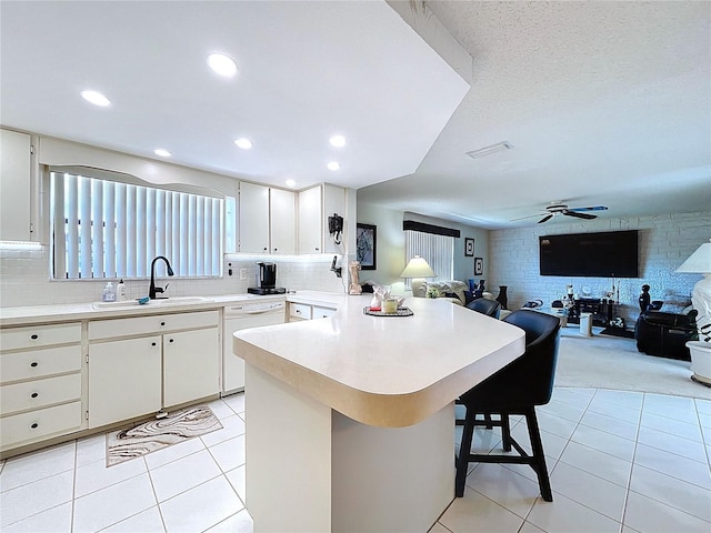 10111 Glen Moor Ln, Port Richey, FL 34668 - kitchen with dishwasher, open floor plan, a peninsula, light countertops, and recessed lighting