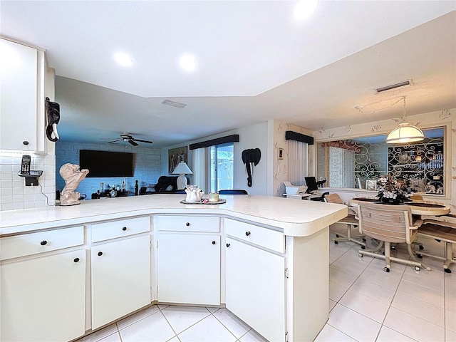 10111 Glen Moor Ln, Port Richey, FL 34668 - kitchen with light tile patterned floors, light countertops, white cabinetry, a peninsula, and recessed lighting