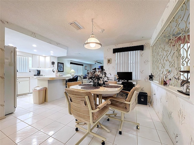 10111 Glen Moor Ln, Port Richey, FL 34668 - dining room with light tile patterned floors and a textured ceiling