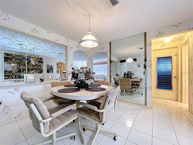 10111 Glen Moor Ln, Port Richey, FL 34668 - dining area with light tile patterned floors and a textured ceiling
