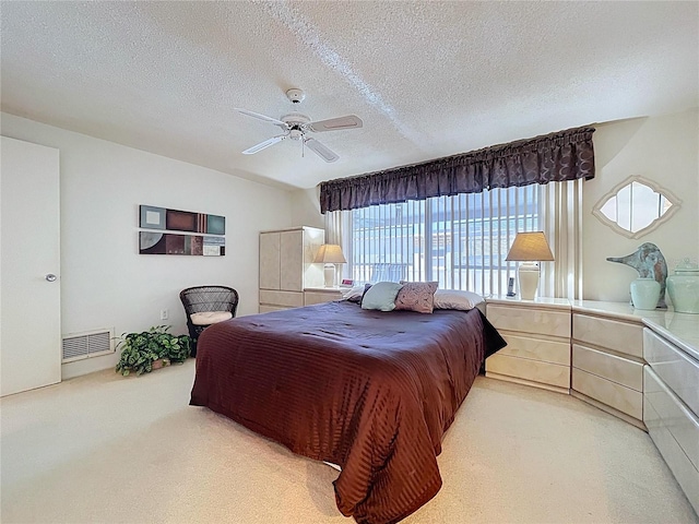 10111 Glen Moor Ln, Port Richey, FL 34668 - bedroom featuring light colored carpet, a textured ceiling, and ceiling fan
