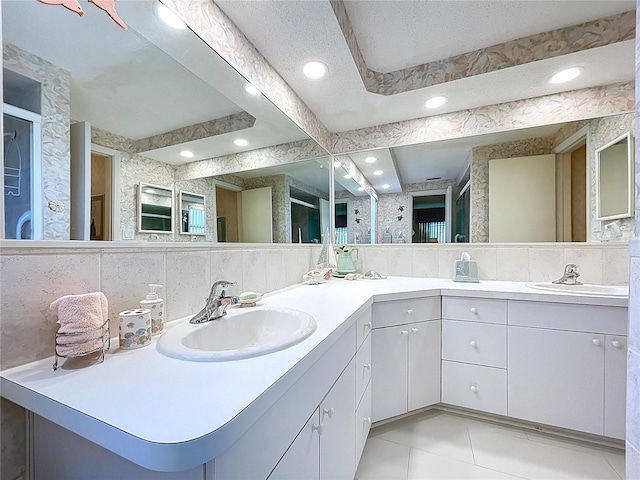 10111 Glen Moor Ln, Port Richey, FL 34668 - bathroom with double vanity, tile patterned floors, recessed lighting, and tasteful backsplash
