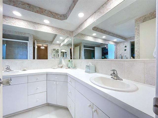 10111 Glen Moor Ln, Port Richey, FL 34668 - bathroom featuring a stall shower, double vanity, recessed lighting, tile patterned flooring, and tasteful backsplash