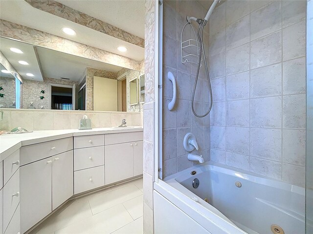 10111 Glen Moor Ln, Port Richey, FL 34668 - bathroom with double vanity, tile patterned floors, recessed lighting, and a combined bath / shower with jetted tub