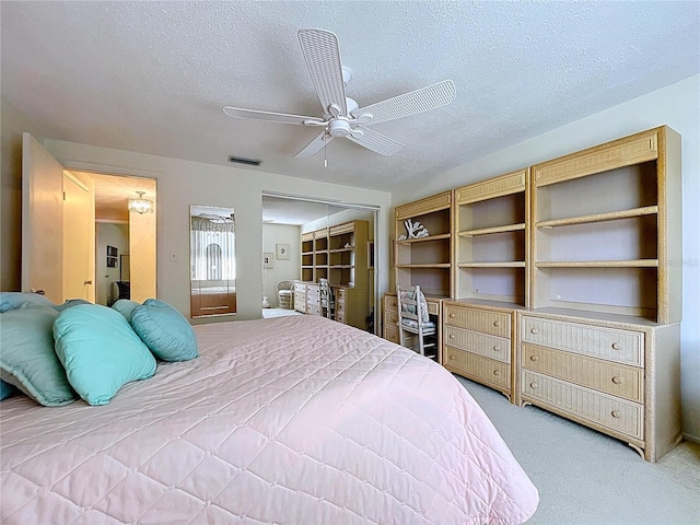 10111 Glen Moor Ln, Port Richey, FL 34668 - bedroom with a textured ceiling, light colored carpet, and a ceiling fan