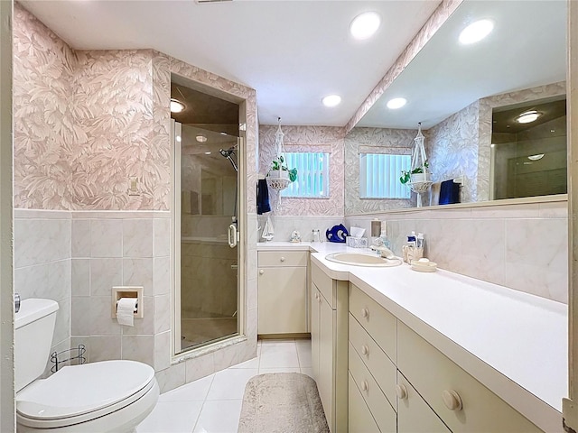 10111 Glen Moor Ln, Port Richey, FL 34668 - full bathroom with tile walls, wallpapered walls, tile patterned floors, vanity, and toilet