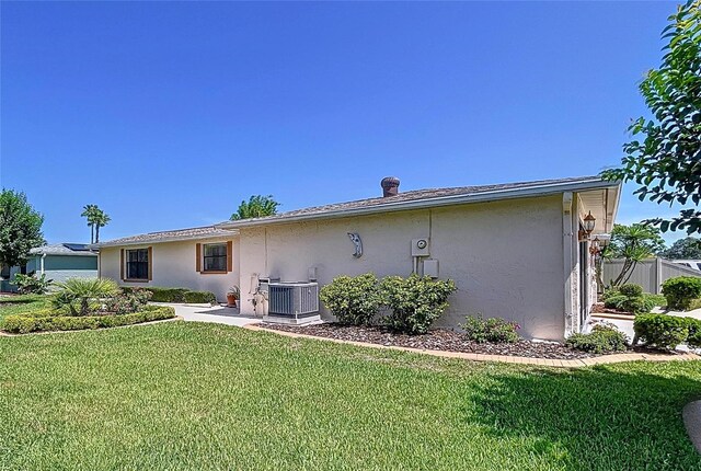 10111 Glen Moor Ln, Port Richey, FL 34668 - view of property exterior featuring stucco siding and central AC