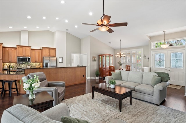 4923 Fort Peck Rd, New Port Richey, FL 34655 - living room with a ceiling fan, high vaulted ceiling, a chandelier, plenty of natural light, and dark wood finished floors