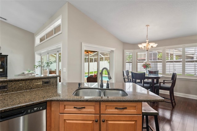 4923 Fort Peck Rd, New Port Richey, FL 34655 - kitchen featuring stainless steel dishwasher, lofted ceiling, a chandelier, dark stone countertops, and dark wood-style flooring