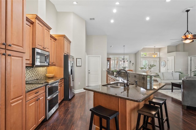 4923 Fort Peck Rd, New Port Richey, FL 34655 - kitchen featuring stainless steel appliances, a kitchen bar, decorative backsplash, open floor plan, and recessed lighting