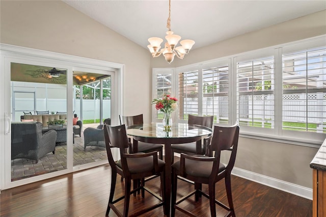 4923 Fort Peck Rd, New Port Richey, FL 34655 - dining room with dark wood-style flooring, a chandelier, and lofted ceiling