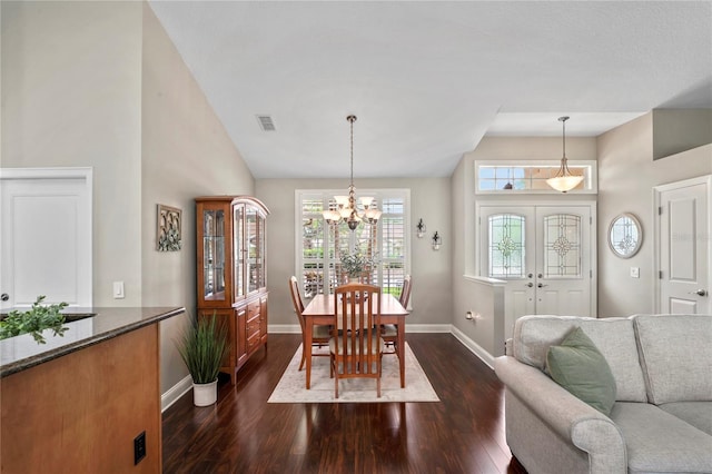 4923 Fort Peck Rd, New Port Richey, FL 34655 - dining area with dark wood-style floors, a chandelier, and high vaulted ceiling