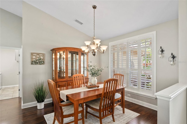4923 Fort Peck Rd, New Port Richey, FL 34655 - dining room with a chandelier, wood finished floors, and vaulted ceiling