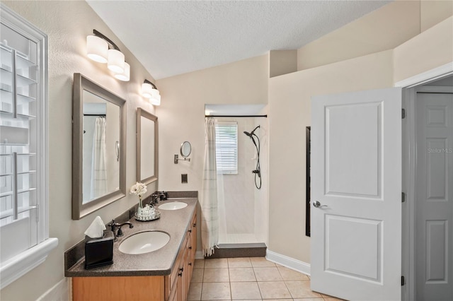 4923 Fort Peck Rd, New Port Richey, FL 34655 - bathroom featuring a tile shower, double vanity, tile patterned floors, a textured ceiling, and lofted ceiling