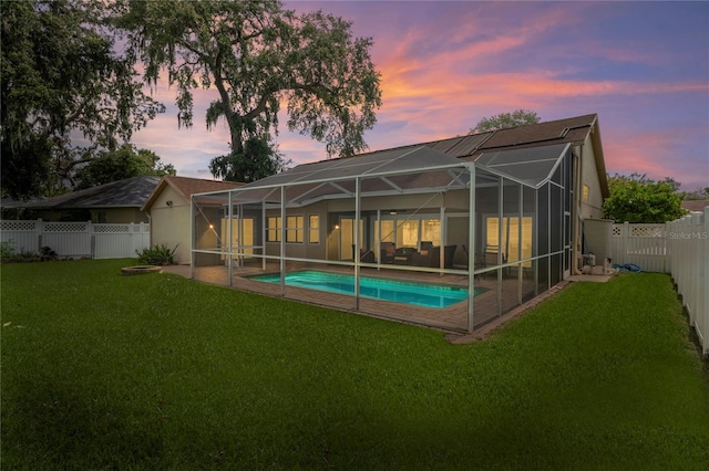 4923 Fort Peck Rd, New Port Richey, FL 34655 - rear view of house with a fenced backyard, a patio area, and a lanai