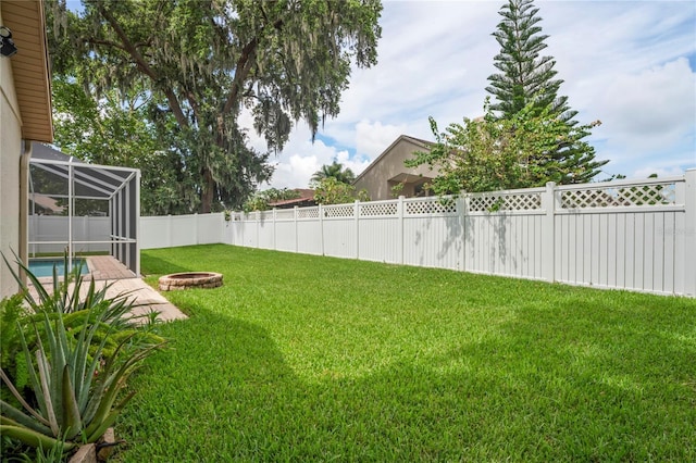 4923 Fort Peck Rd, New Port Richey, FL 34655 - fenced backyard with a fire pit and glass enclosure
