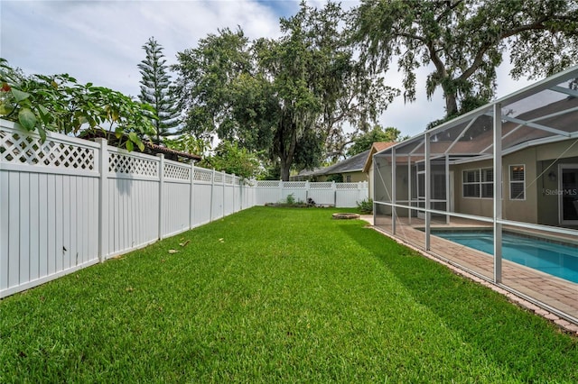 4923 Fort Peck Rd, New Port Richey, FL 34655 - fenced backyard with a lanai and a patio area