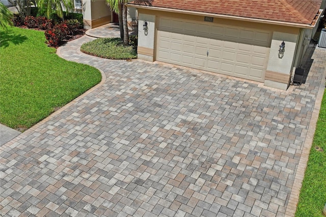 4923 Fort Peck Rd, New Port Richey, FL 34655 - garage featuring decorative driveway
