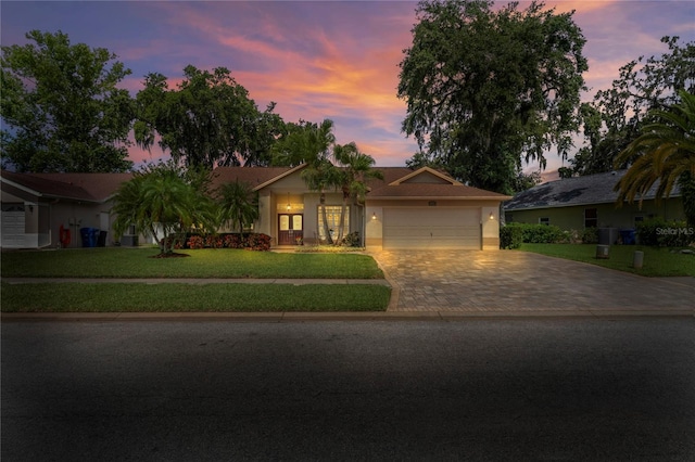 4923 Fort Peck Rd, New Port Richey, FL 34655 - single story home featuring driveway, an attached garage, a front yard, and stucco siding