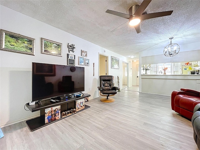 2139 Sea Pines Ct, Spring Hill, FL 34606 - living area with wood finished floors, a textured ceiling, a ceiling fan, a chandelier, and baseboards