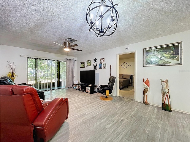 2139 Sea Pines Ct, Spring Hill, FL 34606 - living room with a textured ceiling, wood finished floors, a chandelier, ceiling fan, and baseboards
