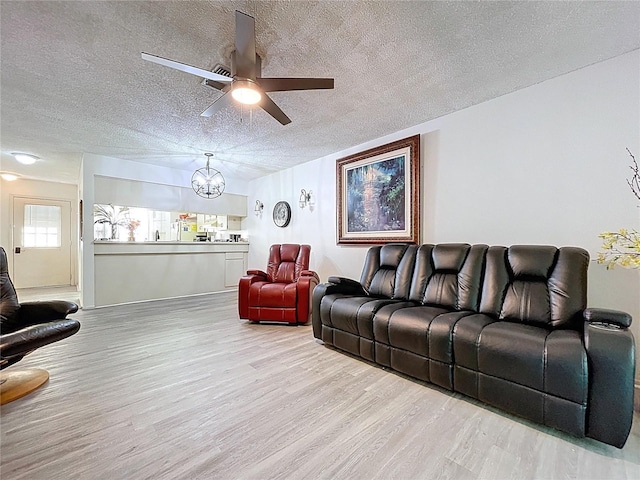 2139 Sea Pines Ct, Spring Hill, FL 34606 - living area with wood finished floors, a textured ceiling, a chandelier, and a ceiling fan