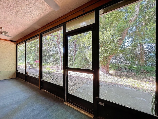 2139 Sea Pines Ct, Spring Hill, FL 34606 - unfurnished sunroom featuring a ceiling fan, a textured ceiling, and a textured wall