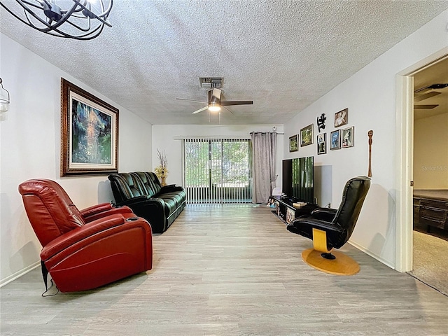 2139 Sea Pines Ct, Spring Hill, FL 34606 - living area with wood finished floors, ceiling fan, a textured ceiling, and baseboards