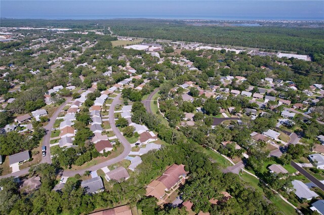 2139 Sea Pines Ct, Spring Hill, FL 34606 - aerial overview of property's location with a forest and nearby suburban area