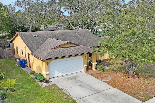 6315 Shane Ln, New Port Richey, FL 34653 - view of front of property with roof with shingles, stucco siding, an attached garage, concrete driveway, and view of scattered trees