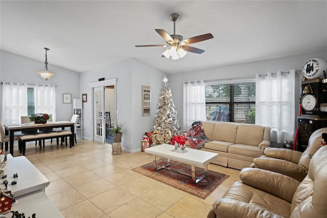 6315 Shane Ln, New Port Richey, FL 34653 - living room featuring lofted ceiling, a ceiling fan, light tile patterned floors, and baseboards