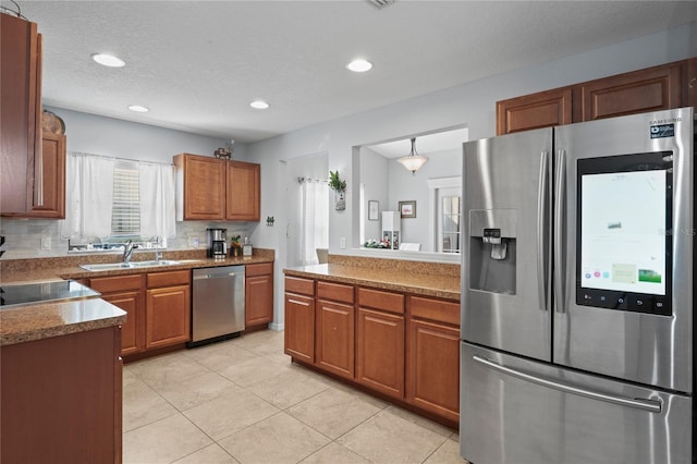 6315 Shane Ln, New Port Richey, FL 34653 - kitchen with appliances with stainless steel finishes, a sink, brown cabinets, light tile patterned flooring, and recessed lighting