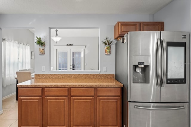 6315 Shane Ln, New Port Richey, FL 34653 - kitchen with stainless steel fridge with ice dispenser, brown cabinets, light countertops, and light tile patterned floors