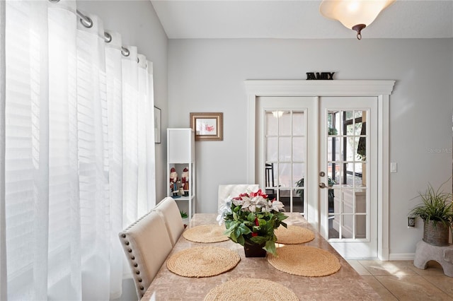 6315 Shane Ln, New Port Richey, FL 34653 - dining area with tile patterned floors, french doors, and baseboards