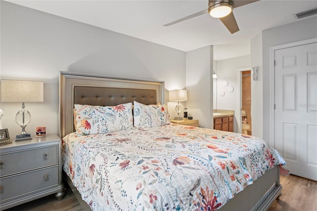 6315 Shane Ln, New Port Richey, FL 34653 - bedroom featuring wood finished floors, connected bathroom, and a ceiling fan