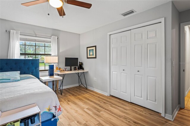 6315 Shane Ln, New Port Richey, FL 34653 - bedroom with light wood-style flooring, baseboards, a closet, ceiling fan, and an office area