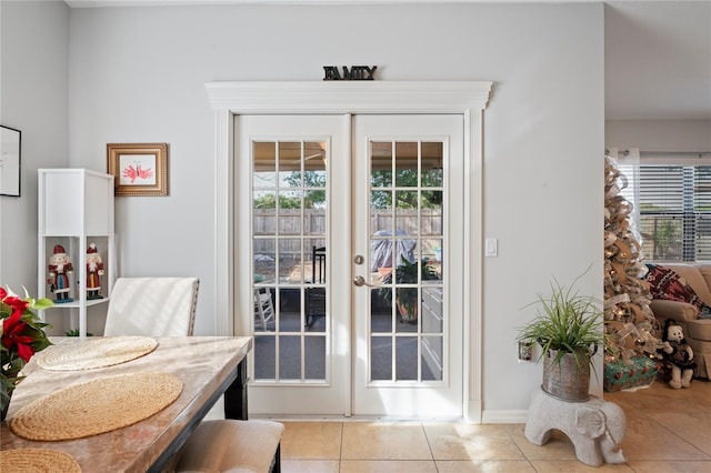 6315 Shane Ln, New Port Richey, FL 34653 - doorway to outside with french doors, light tile patterned floors, and baseboards